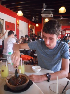Ben stirring claypot noodles on the food tour